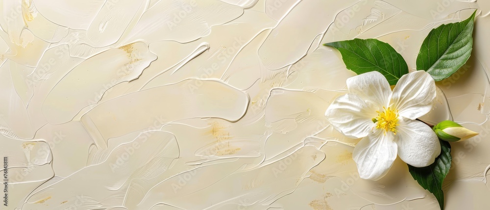   A white flower with green leaves on a beige background, featuring a prominent green leaf