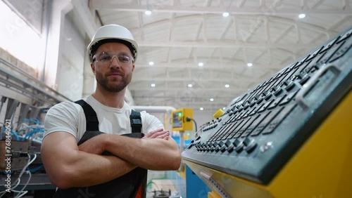 Portrait of engineer operator near CNC machine in factory industries photo