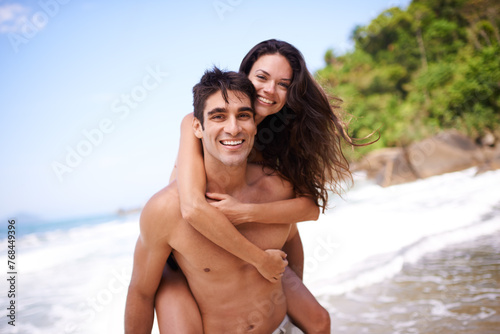 Piggyback, love and portrait of couple at beach on vacation, adventure or holiday for romantic travel. Happy, smile and young man and woman on date by ocean for tropical anniversary weekend trip.