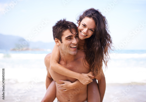 Piggyback, beach and portrait of couple on vacation, adventure or holiday for romantic travel. Happy, love and young man and woman on date by ocean for tropical outdoor anniversary weekend trip.
