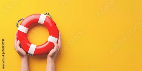 A person is holding a red life lifebuoy