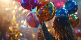A woman is holding a bunch of balloons and is surrounded by colorful lights