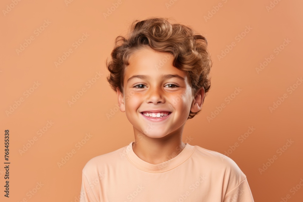 Portrait of a cute smiling little boy with curly hair on a brown background Portrait of a cute smiling little boy with curly hair on a brown background