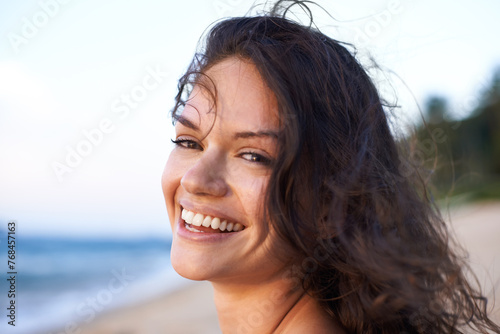 Happy, beach and portrait of woman in summer for vacation, holiday and weekend outdoors. Nature, travel and face of person with smile for relaxing, adventure and freedom by ocean on tropical island © peopleimages.com