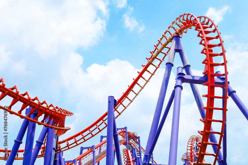 close-up image of a roller coaster track and the blue sky close-up image of a roller coaster track and the blue sky