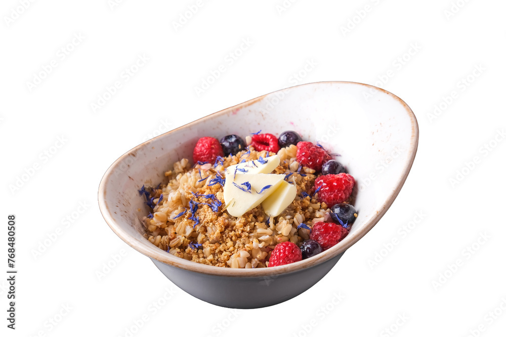 Oatmeal with berries and nuts. Porridge with raspberry, blueberry, nuts and butter in a plate. White background. Healthy breakfast concept Oatmeal with berries and nuts. Porridge with raspberry, blueberry, nuts and butter in a plate. White background. Healthy breakfast concept