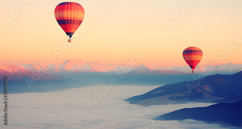 two hot air balloons flying above the clouds