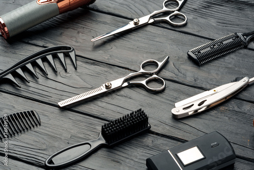 Professional Barber Tools Laid Out on Dark Wooden Surface