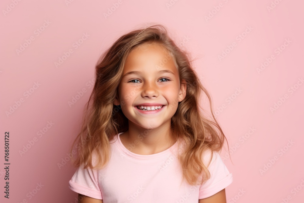 Portrait of smiling little girl with long blond hair on pink background Portrait of smiling little girl with long blond hair on pink background