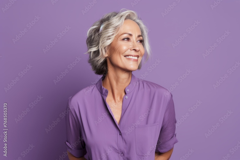 Portrait of smiling senior woman looking at camera over purple background. Portrait of smiling senior woman looking at camera over purple background.