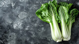 Whole bok choy with lush leaves against a dark backdrop.