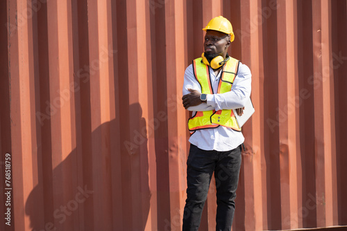 African logistic engineer man worker or foreman working with container at container site 