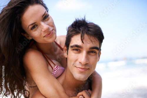 Piggyback, travel and portrait of couple at beach on vacation, adventure or holiday for romance. Happy, love and young man and woman on date by ocean for tropical outdoor anniversary weekend trip.