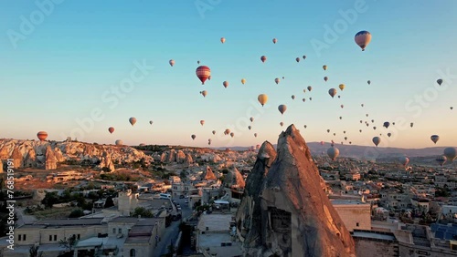 Hot air balloons in cappadocia at sunrise, fly in the sky over a mountain valley Aerial view. The vibrant balloons rise gracefully over the valley, Goreme. Enchanting spectacle of a hot air balloon photo