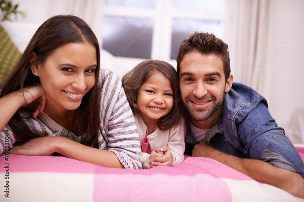 Family, portrait and girl in bedroom for love, happiness and relaxing in house. Bonding, bed and caring parents with little child enjoying time together, smiling and laying down in apartment Family, portrait and girl in bedroom for love, happiness and relaxing in house. Bonding, bed and caring parents with little child enjoying time together, smiling and laying down in apartment