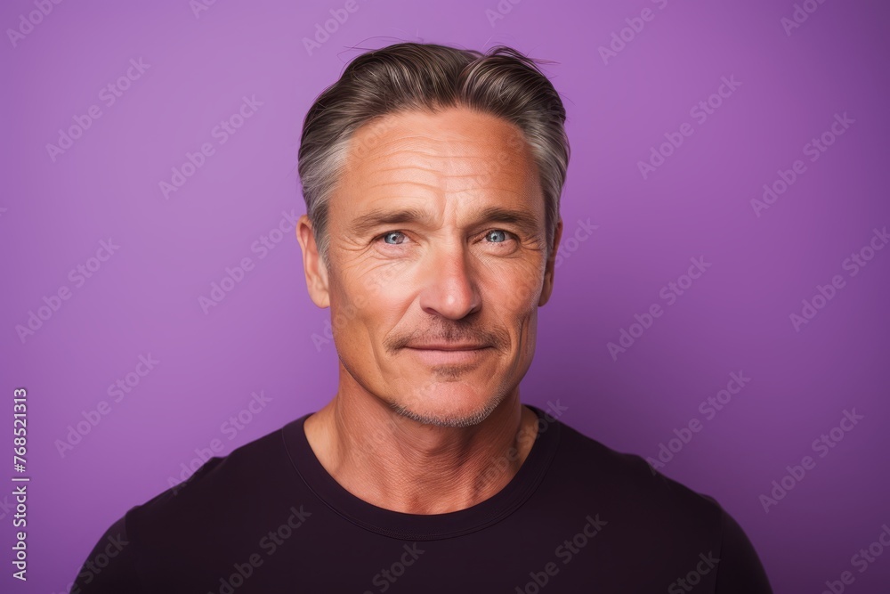 Portrait of a middle-aged man on a purple background. Portrait of a middle-aged man on a purple background.