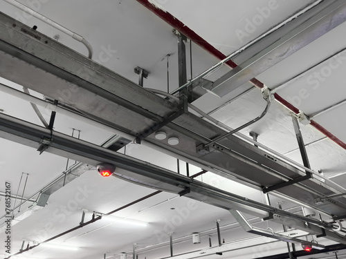 Lights and ventilation system in long line on ceiling of the industrial building. Exhibition Hall. Ceiling factory construction.