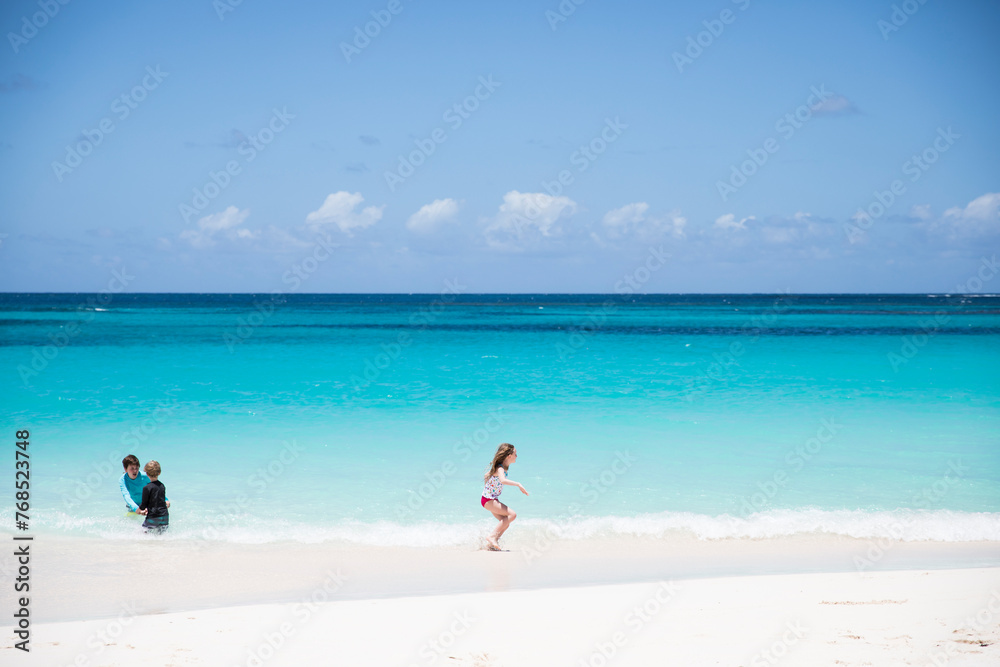 Wide View of Siblings Playing Together on Shoal Bay Beach in Anguilla Wide View of Siblings Playing Together on Shoal Bay Beach in Anguilla