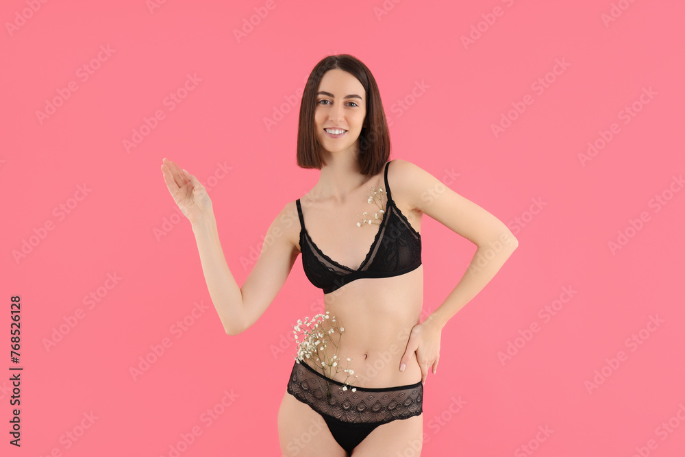 Slim girl in underwear with flowers, on a pink background. Slim girl in underwear with flowers, on a pink background.