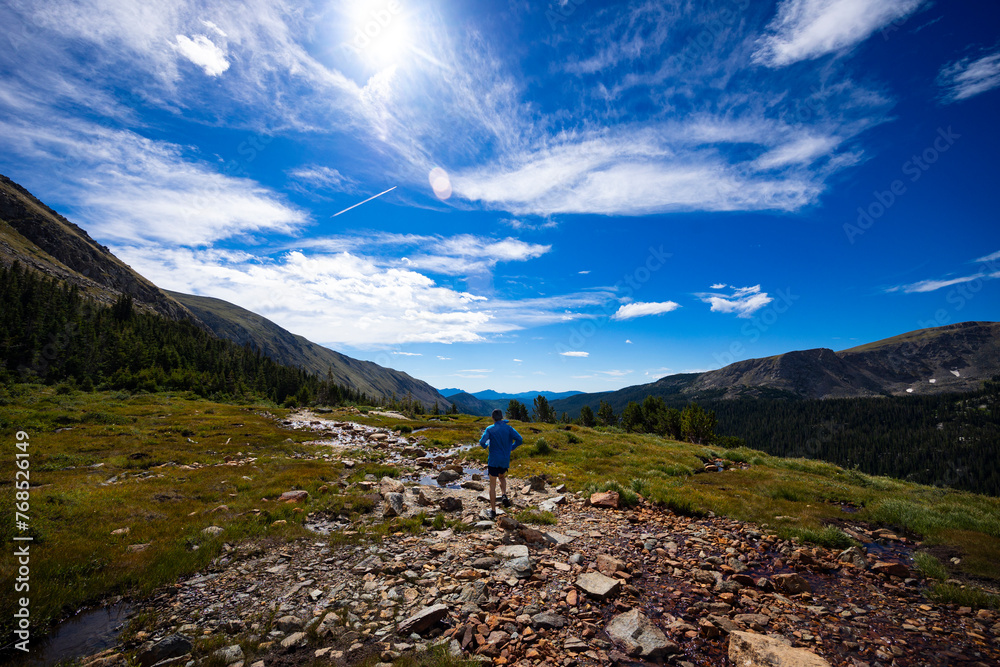 Trail runner on the trail up to Arapahoe Pass in Colorado. Trail runner on the trail up to Arapahoe Pass in Colorado.