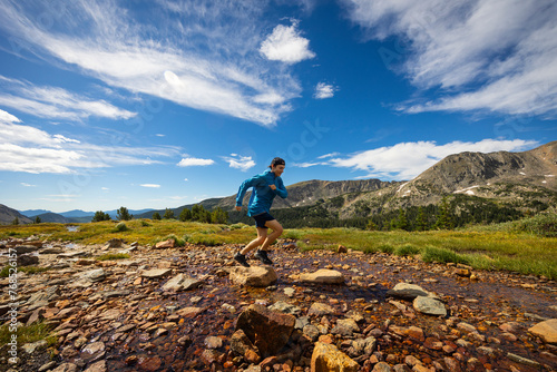 Trail runner on the trail up to Arapahoe Pass in Colorado. photo