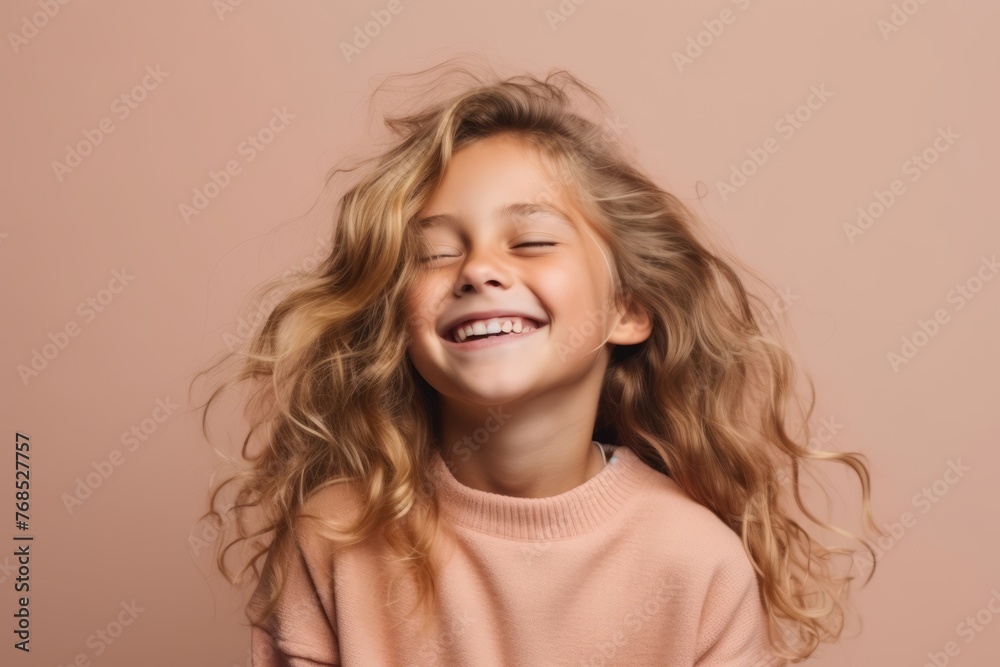 Portrait of happy little girl with long curly hair over pink background Portrait of happy little girl with long curly hair over pink background
