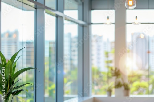 beautiful bright blurred office banner background with glass elements and lights and green plants photo