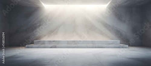 An empty room with a staircase leading upwards to a source of bright light. The room features white marble flooring and a dark abstract wall, creating a stark contrast with the illumination from above photo