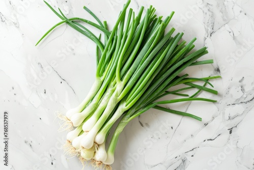 A bunch of green onions neatly arranged on a kitchen counter