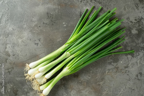 A bunch of green onions neatly arranged on a table  ready for cooking or garnishing dishes