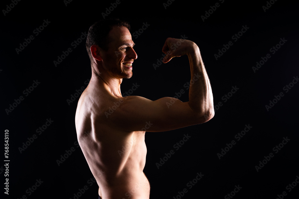 Portrait of man, bodybuilder and bicep flex in studio, background and exercise for muscular power.