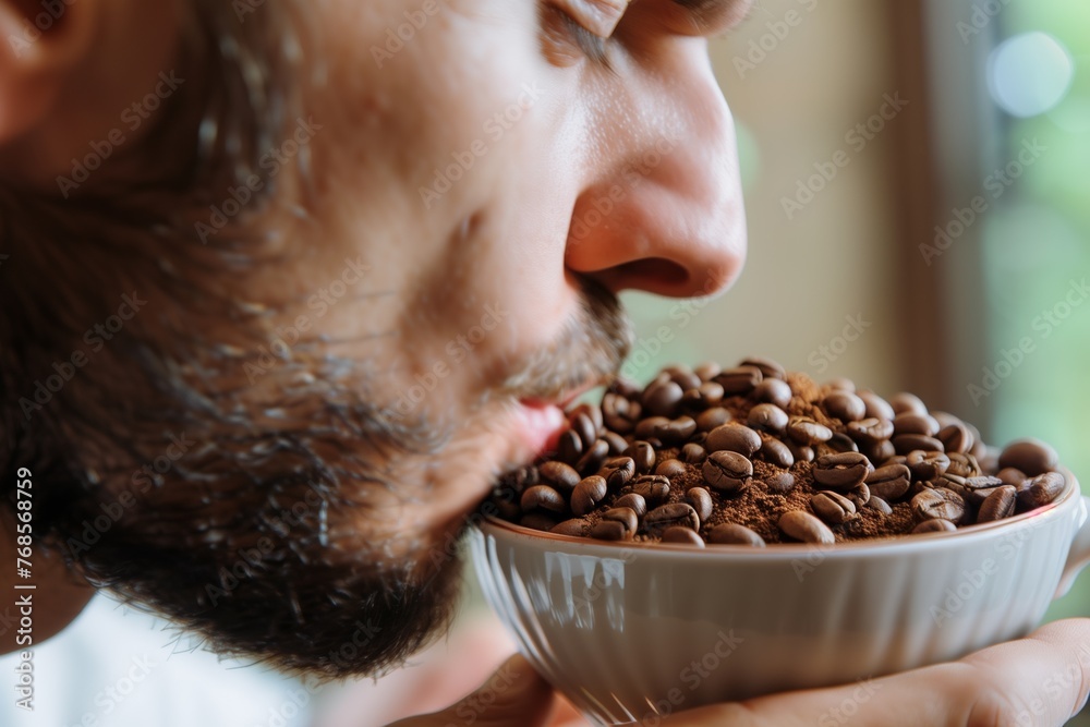 man smelling freshly ground exotic coffee beans - obrazy, fototapety, plakaty 