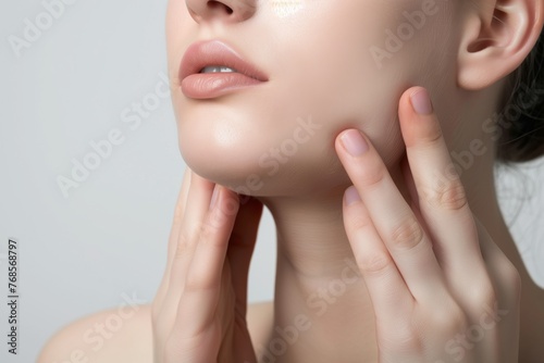 two hands lifting the skin along a jawline upward