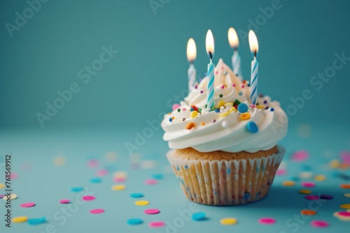 a birthday cupcake with candles sitting on a blue background