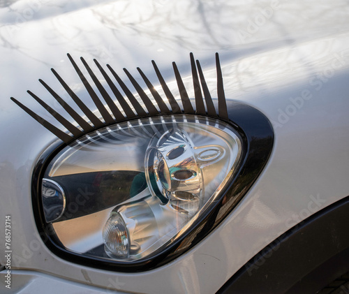 modified headlights of a modern car like a woman eye