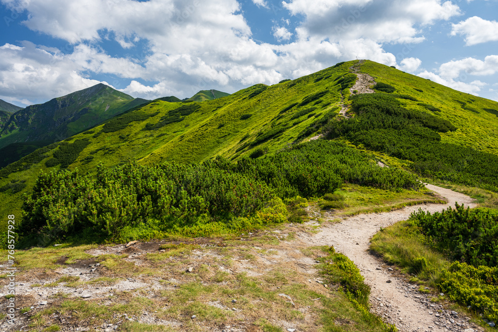 Picturesque hiking trail in summer day. Beautiful view on West Tatras Mountains peaks, Poland. Popular travel and tourism destination for active lifestyle, sport and climbing activity.
