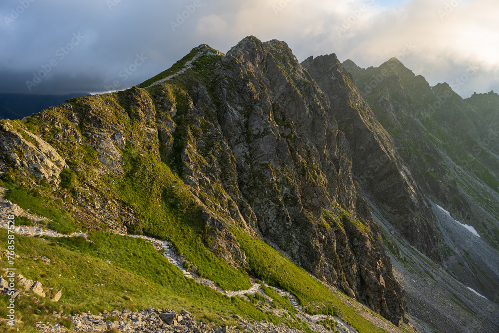 Steep hike path to Krzyzne Pass in Tatra Mountains at summer day. Beautiful view on Orla Perc peaks.