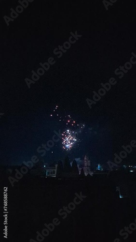 Slow motion of firecrackers bursting against a dark background during Diwali celebrations in Khambhat, India photo