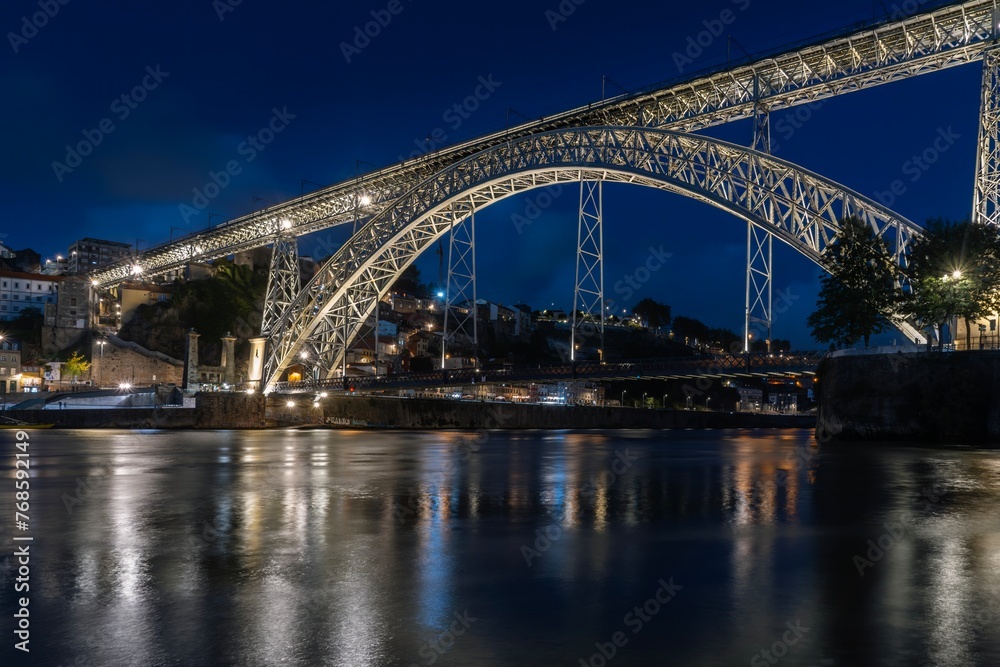 Night skyline from the Dom Luis I bridge in Porto, Portugal, on the banks of the Douro river, cityscape at night.
