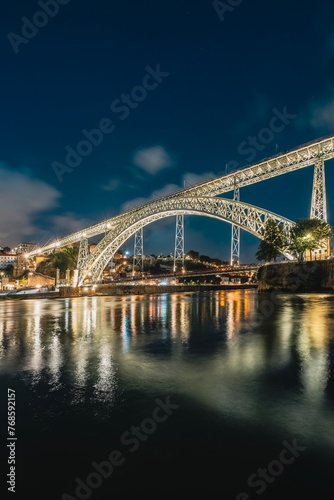 Night skyline from the Dom Luis I bridge in Porto, Portugal, on the banks of the Douro river, cityscape at night.