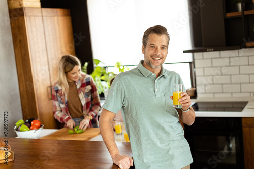 Smiling man holds a glass o...