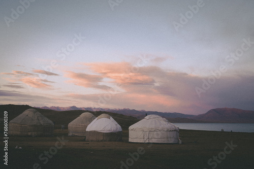 Magnificent scenery in Kyrgyzstan. Depicts nomadic life, with yurts, horsemen and nomads. Mountain and sunset hikiing in a steppe. Farm isolated.