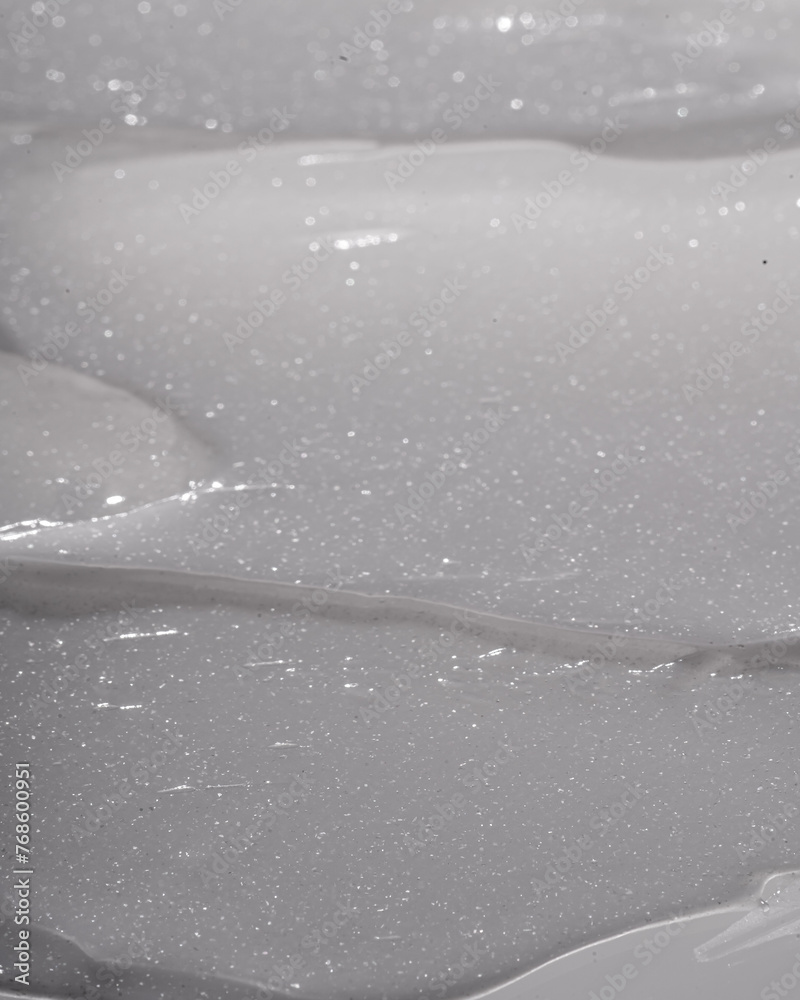 Fototapeta premium The texture of a radiant highlighting body lotion, shot in macro. Body cream texture.