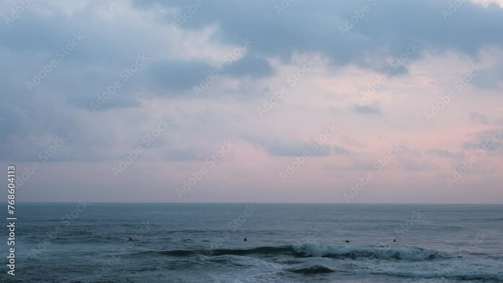 Surfers On Tropical Beach With Birds Flying During Sunset In Bali, Indonesia. Slow Motion Shot Surfers On Tropical Beach With Birds Flying During Sunset In Bali, Indonesia. Slow Motion Shot
