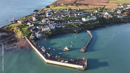 Drone video of Ballycotton Pier in Ballycotton Cork Ireland - showing the Pier, Atlantic ocean and boats (including a rescue boat) photo