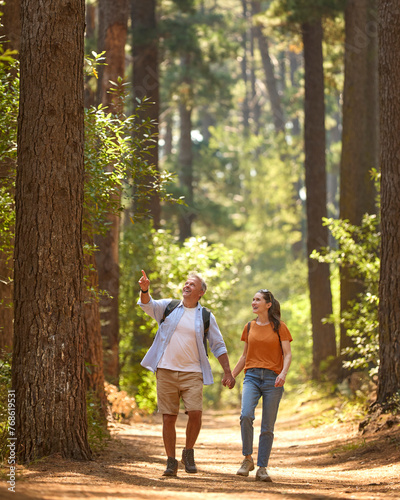 Senior Retired Couple Holding Hands Hiking Along Trail In Countryside © Monkey Business