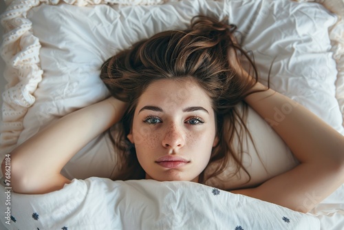 Woman Laying in Bed Under Blanket