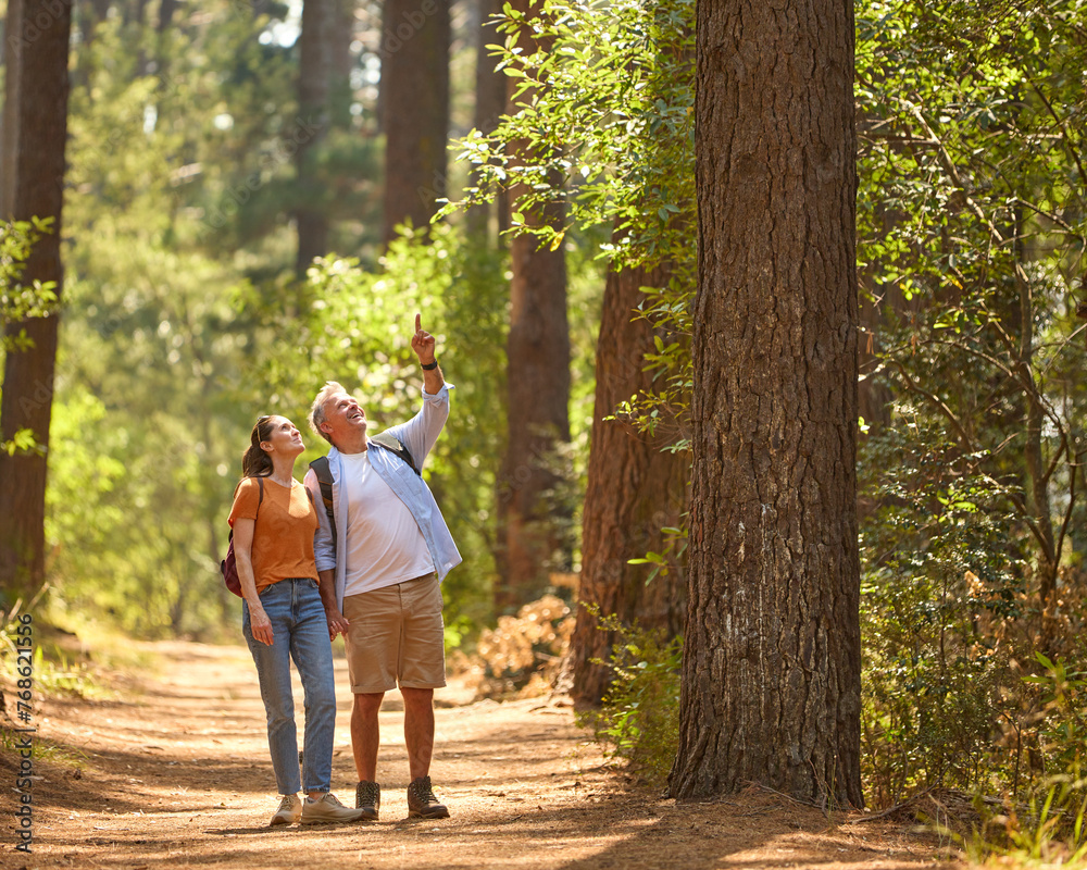 Senior Man Pointing As Retired Couple Hold Hands And Hike Along Trail In Countryside Senior Man Pointing As Retired Couple Hold Hands And Hike Along Trail In Countryside