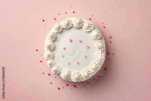Cake with white whipped cream and colorful sprinkles. Top view isolated on pile pink background