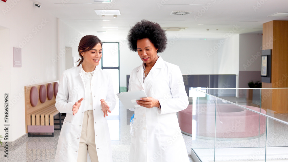 Two female doctors consulting about some patients Two female doctors consulting about some patients